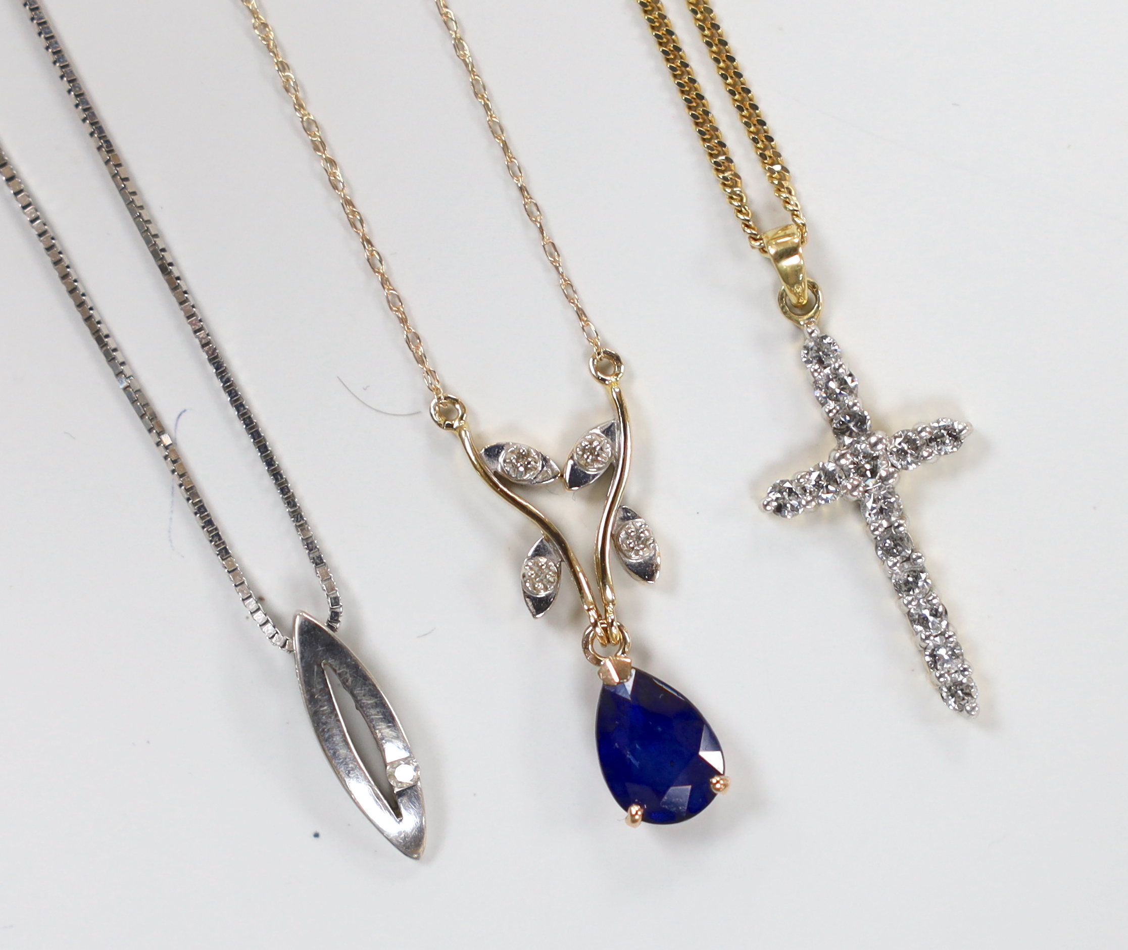 A modern 14kt yellow metal, sapphire and diamond chip set drop pendant necklace, 46cm, gross 1.6 grams, a similar 18ct gold and diamond set cross pendant, on a 9ct chain and one other 9ct and gem set pendant necklace, gr